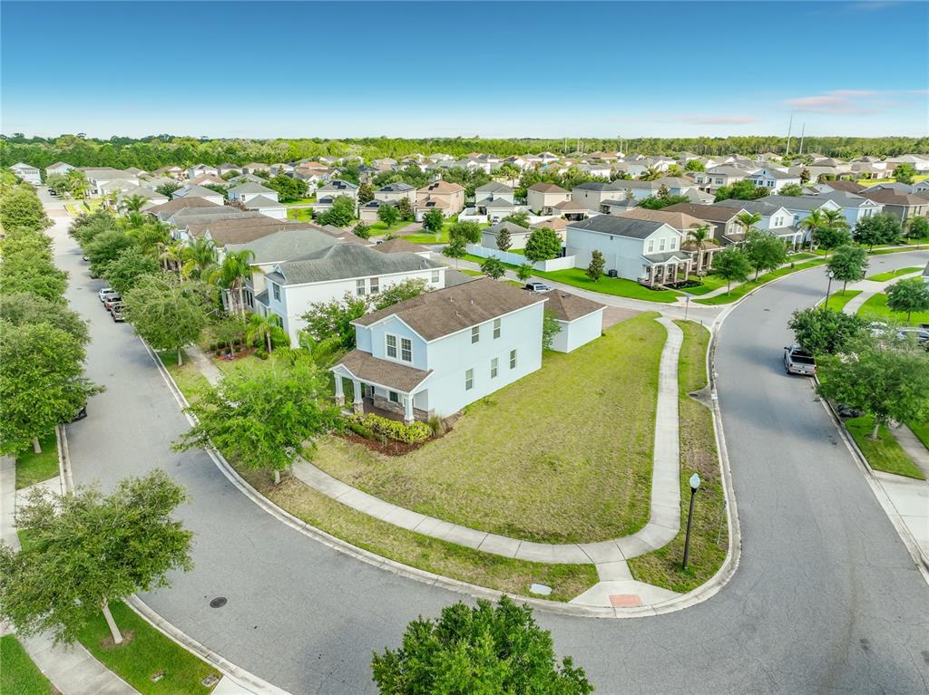 An aerial view shows a two-story house situated on a corner lot in a neighborhood — 11143 SYCAMORE WOODS DRIVE, ORLANDO, FL