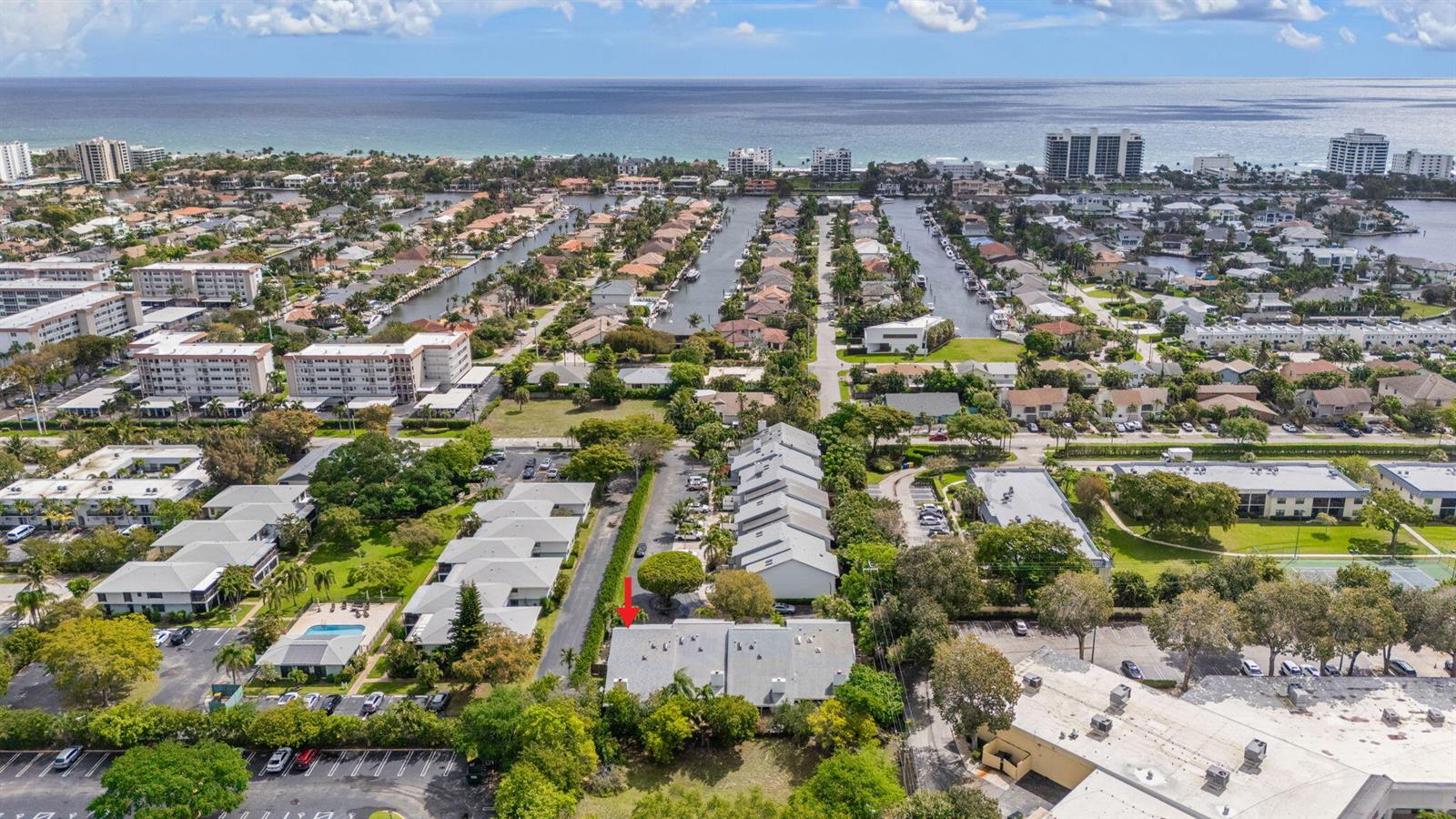 An aerial view shows a residential neighborhood with a red arrow pointing to a townhouse — 2956 Florida Boulevard, Delray Beach FL 33483, DELRAY BEACH, FL