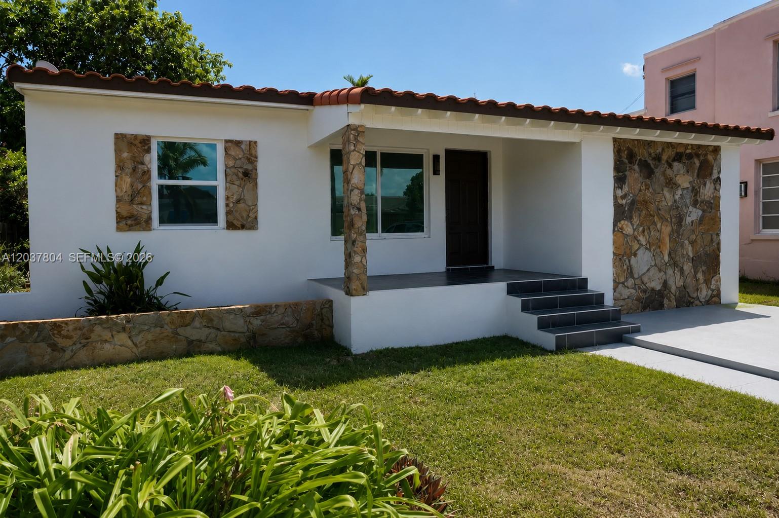 A single-story house features white stucco walls, stone accents, and a red tile roof — 4240 SW 14th St, Miami FL 33134, MIAMI, FL