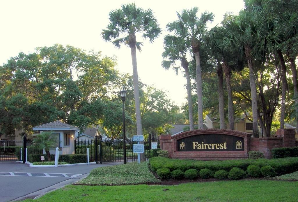 A brick entrance sign for Faircrest sits beside a gated community entrance with palm trees — 5100 BURCHETTE ROAD UNIT 3802, TAMPA, FL