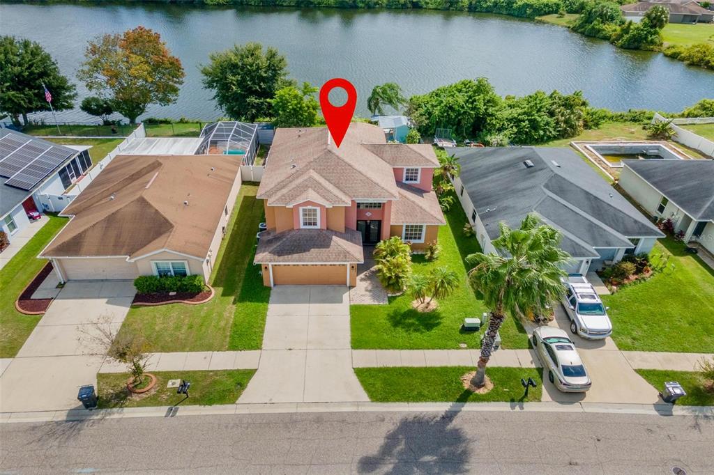 An aerial view of a two-story suburban house with a red pin marker — 11302 SOUTHWIND LAKE DRIVE, GIBSONTON, FL