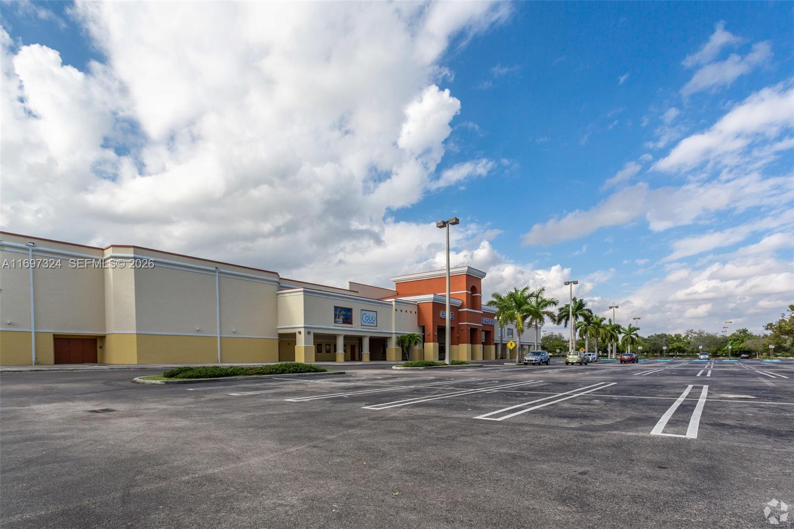 A large commercial building with a parking lot under a blue sky with clouds — 17355 NW 59th Ave, Hialeah FL 33015, HIALEAH, FL