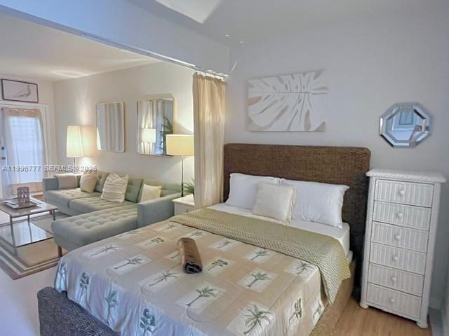 A studio apartment features a bed, a sectional sofa, and a white wicker dresser — 1050 Pennsylvania Ave # 28, Miami Beach FL 33139, MIAMI BEACH, FL