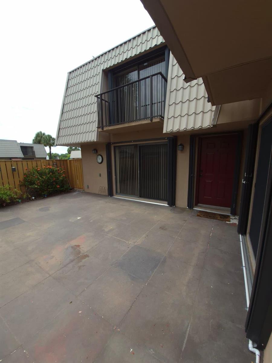 A kitchen features wood cabinets, granite countertops, stainless steel appliances, and a gray tile floor — 5012 50th Way, West Palm Beach FL 33409, WEST PALM BEACH, FL