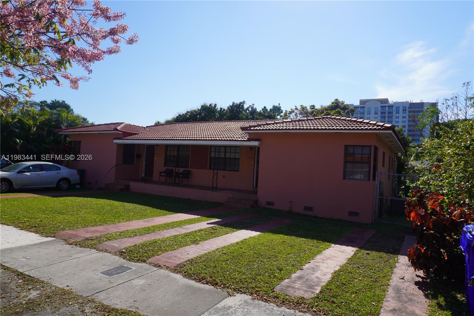 A single-story peach-colored house with a tiled roof and a front porch sits on a lot — 2660 SW 36th Ave, Miami FL 33133, MIAMI, FL