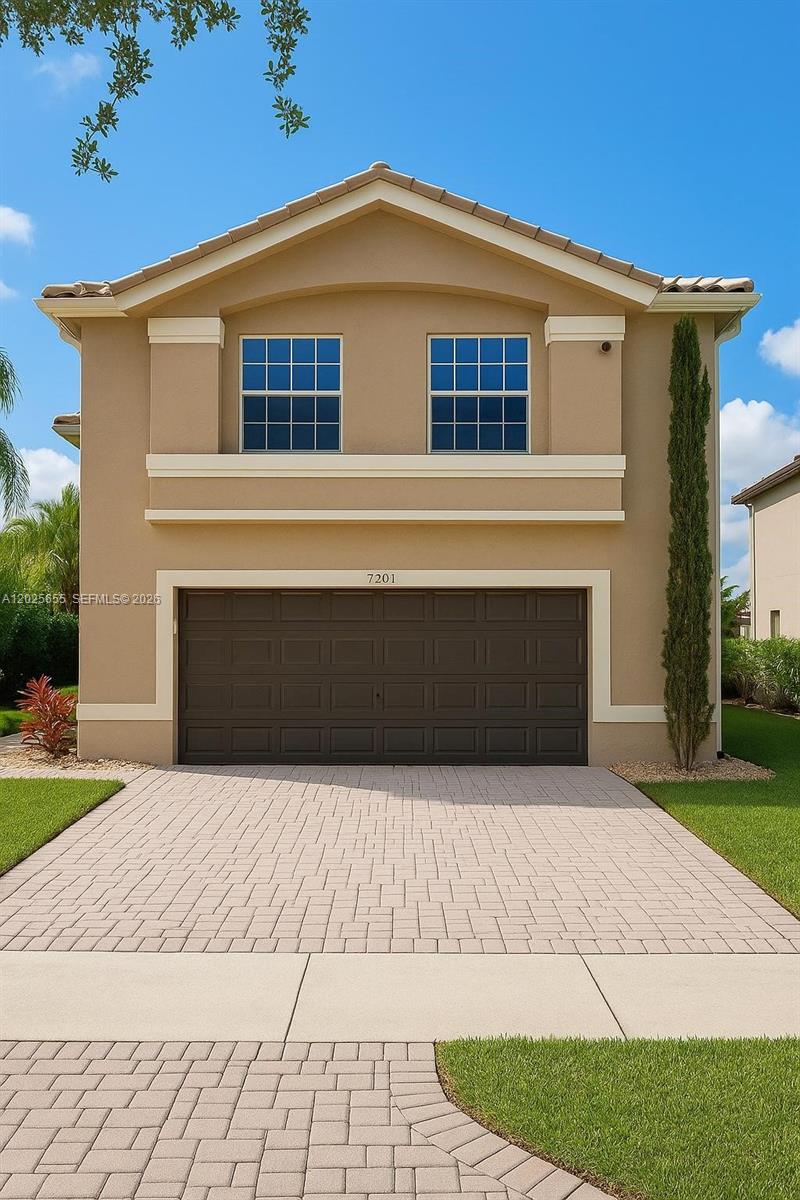 A two-story house with a tan stucco exterior and a two-car garage — 2950 SW 163rd Ave # 0, Miramar FL 33027, MIRAMAR, FL