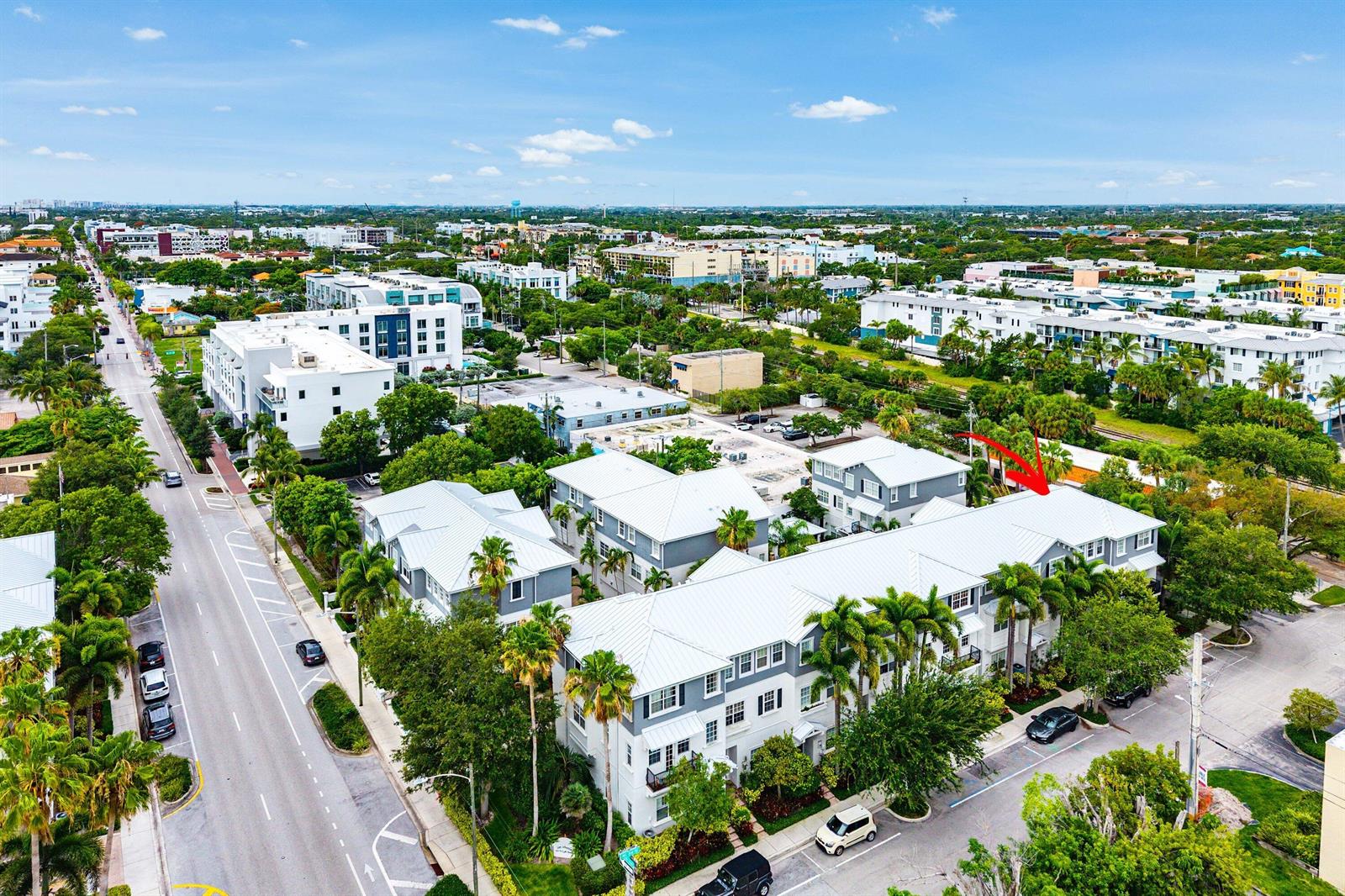 An aerial view of a multi-story residential complex with white roofs and surrounding palm trees — 290 NE 5th Avenue # 9, Delray Beach FL 33483, DELRAY BEACH, FL