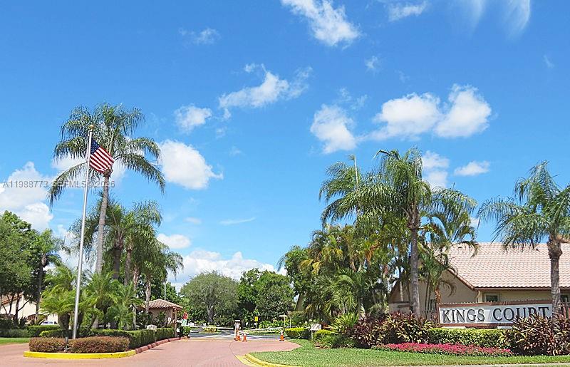A gated entrance sign for Kings Court features palm trees and an American flag — 11378 SW 84th Ln, Miami FL 33173, MIAMI, FL