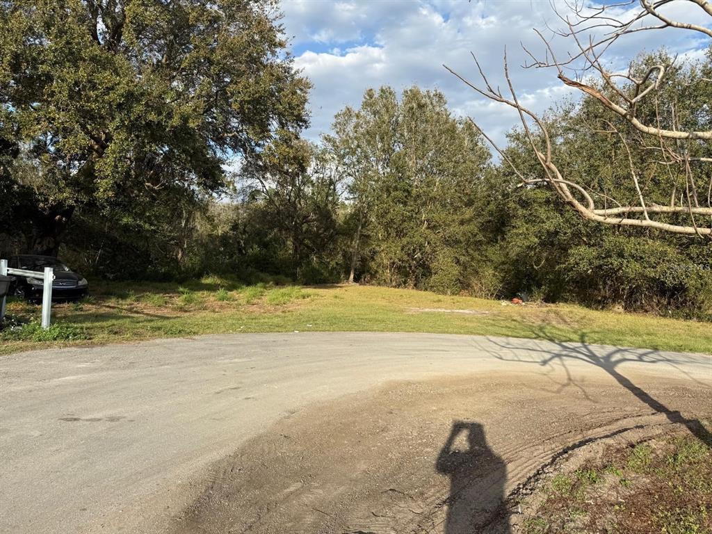 A vacant, grassy residential lot sits at the end of a paved cul-de-sac — CANAL COURT, LAKE WALES, FL
