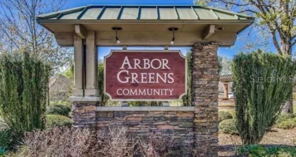 A stone monument sign for the Arbor Greens community stands outdoors under a metal roof — 1336 NW 132ND CIRCLE, NEWBERRY, FL