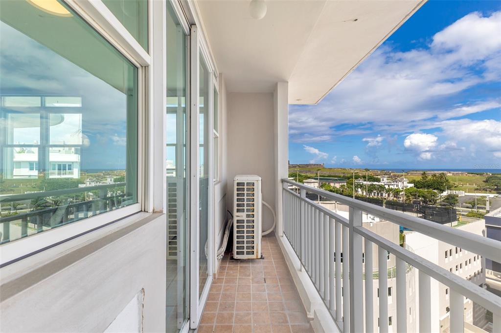 A balcony view overlooking a tennis court, a historic fort, and the ocean in San Juan — 100 CALLE DEL MUELLE UNIT 21007, OLD SAN JUAN, PR