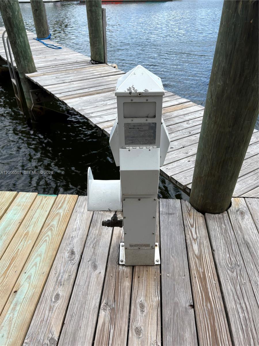 A white utility pedestal stands on a wooden dock next to a body of water — 2415 NW 16th St Rd #11, Miami FL 33125, MIAMI, FL