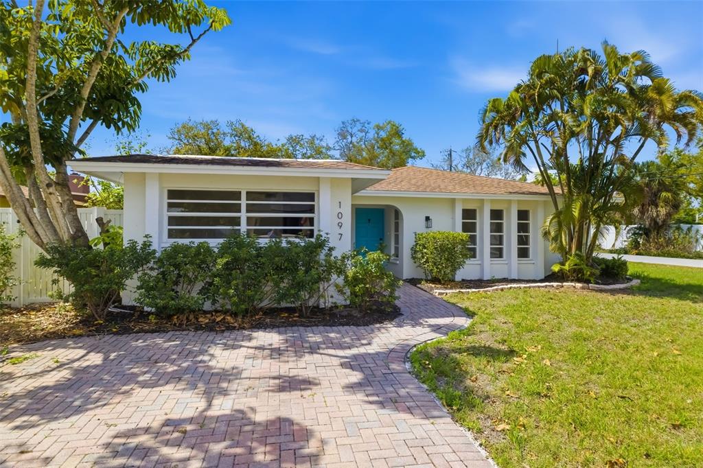 An aerial view shows a white single-story house with a brown shingled roof and walkway — 1097 WILLIS AVENUE, SARASOTA, FL