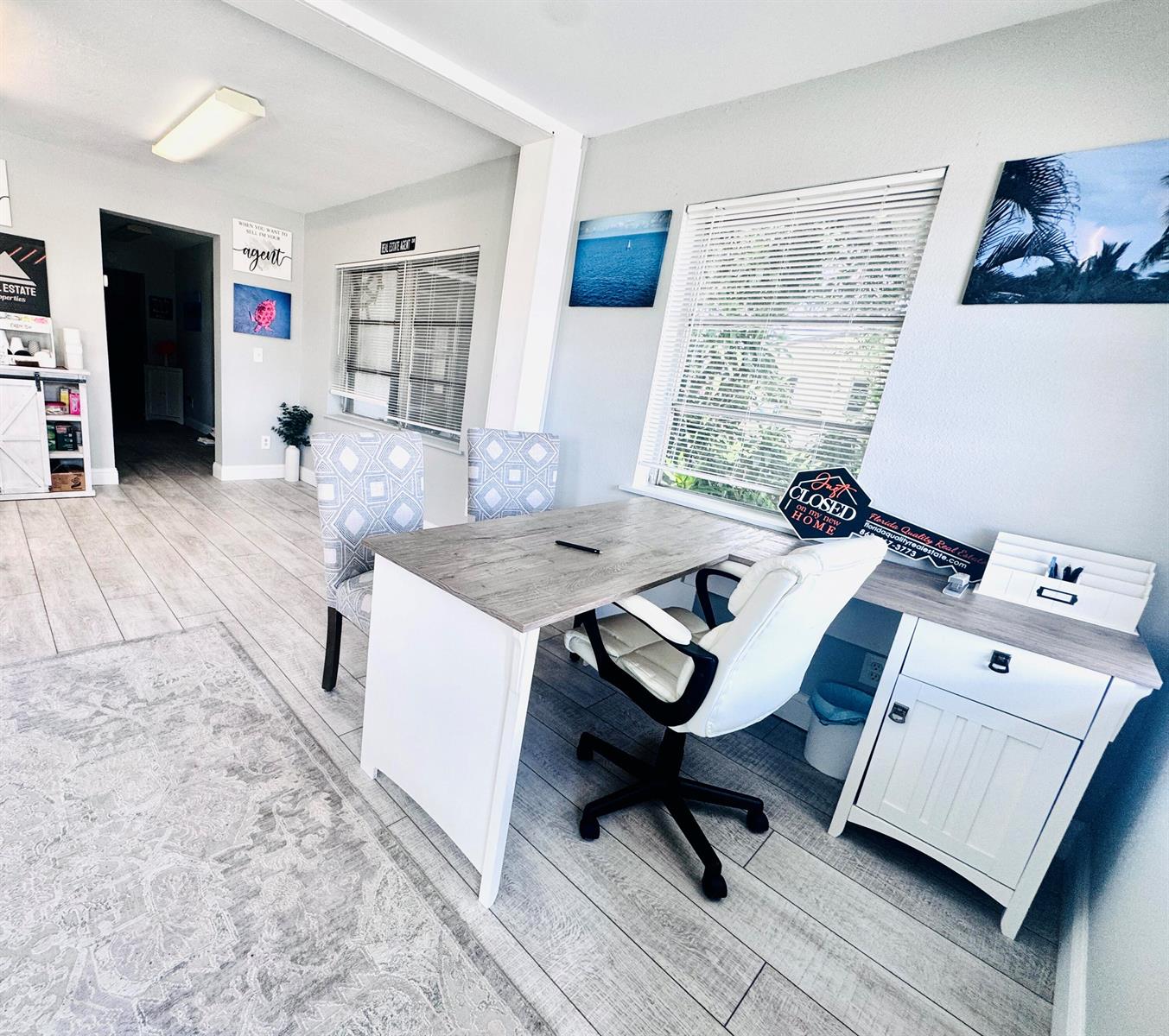 A bright office space features a wooden desk, white chairs, and light-colored wood-look flooring — 206 SW 3rd Street, Okeechobee FL 34974, OKEECHOBEE, FL