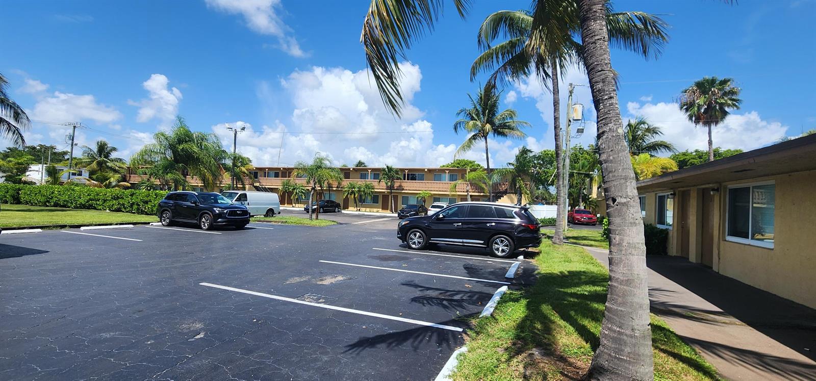 A parking lot in front of a two-story apartment building with palm trees — 620 NW 7th Avenue # 28, Pompano Beach FL 33060, POMPANO BEACH, FL