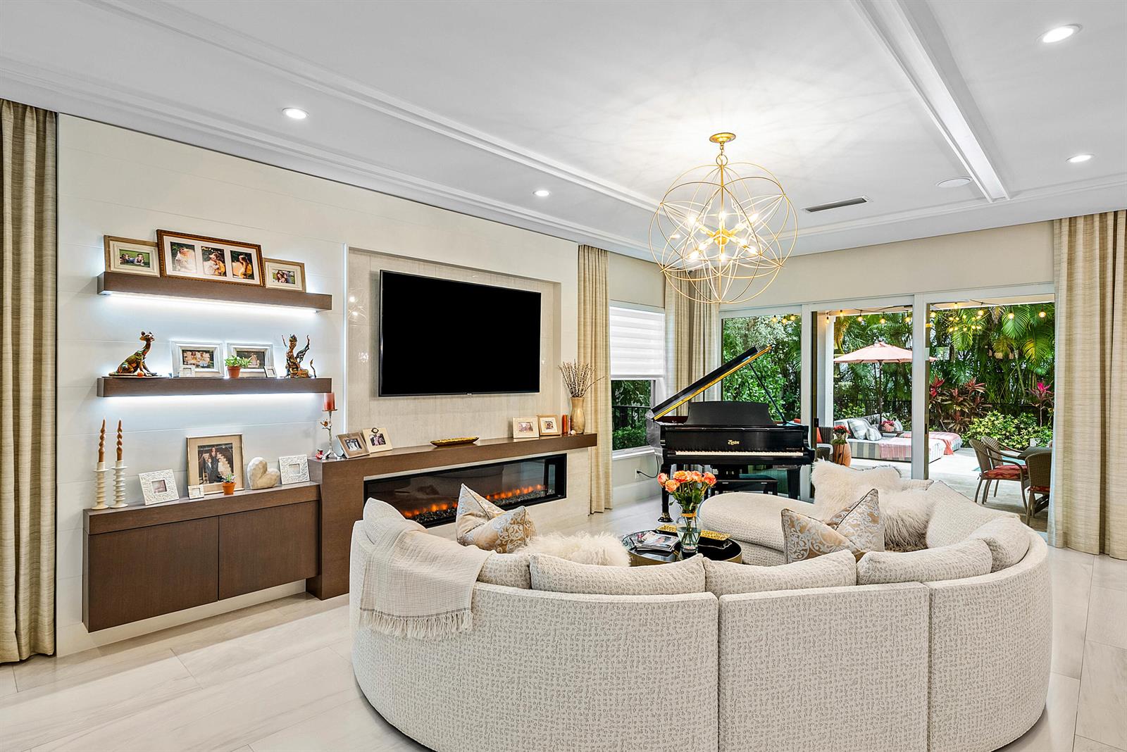 A living room features a curved sofa, fireplace, wall-mounted television, and a grand piano — 436 NE Wavecrest Way, Boca Raton FL 33432, BOCA RATON, FL