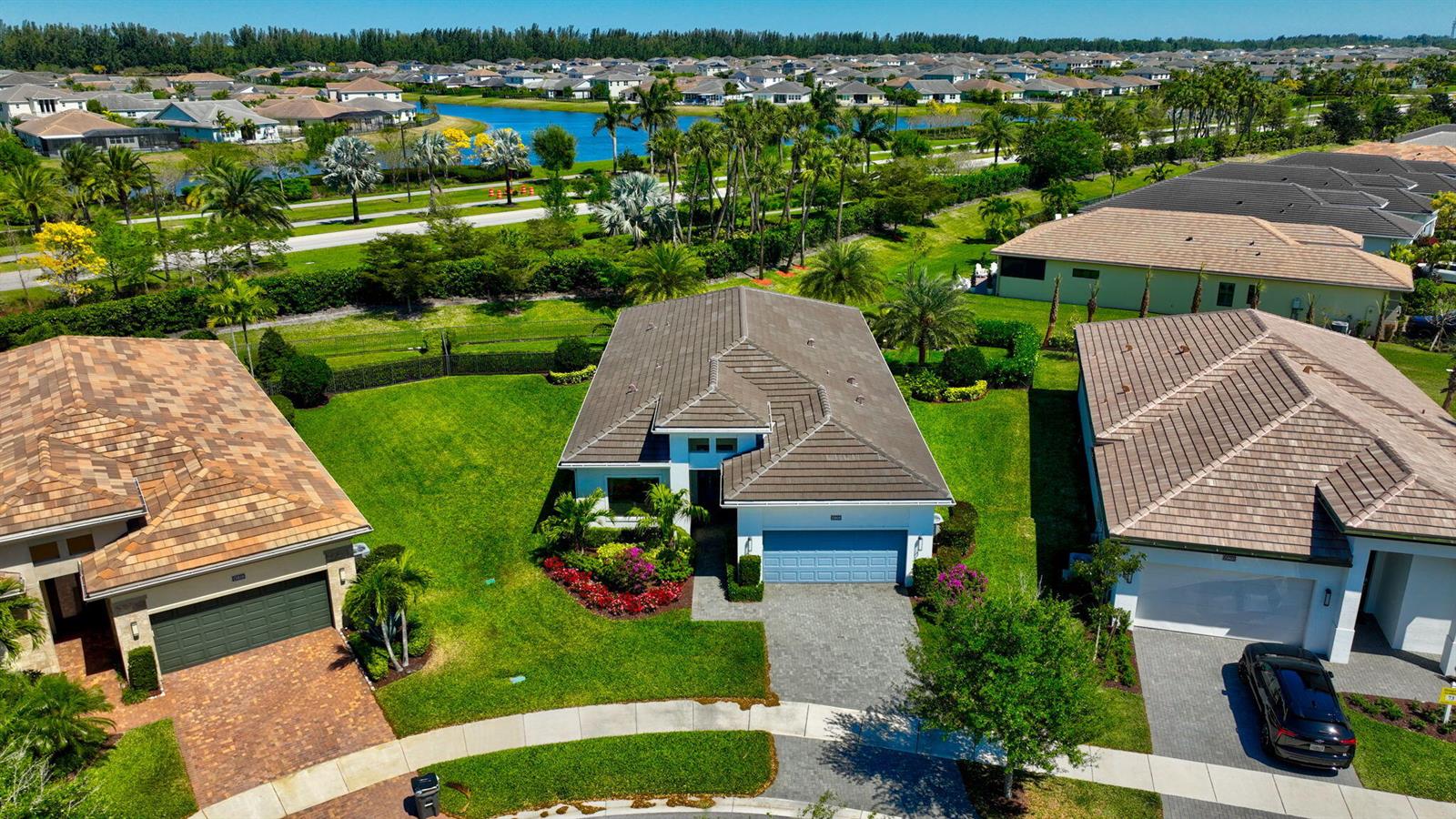 An aerial view of a suburban house with a tiled roof and a paved driveway — 15808 Amelia Terrace, Westlake FL 33470, WESTLAKE, FL
