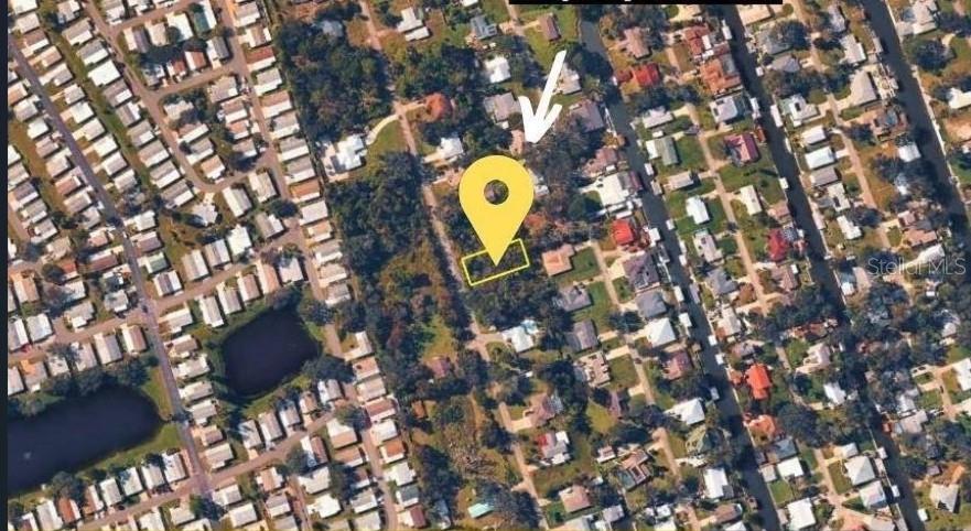 This aerial map shows a highlighted vacant lot surrounded by residential houses and trees — POINCIANA ROAD, EDGEWATER, FL