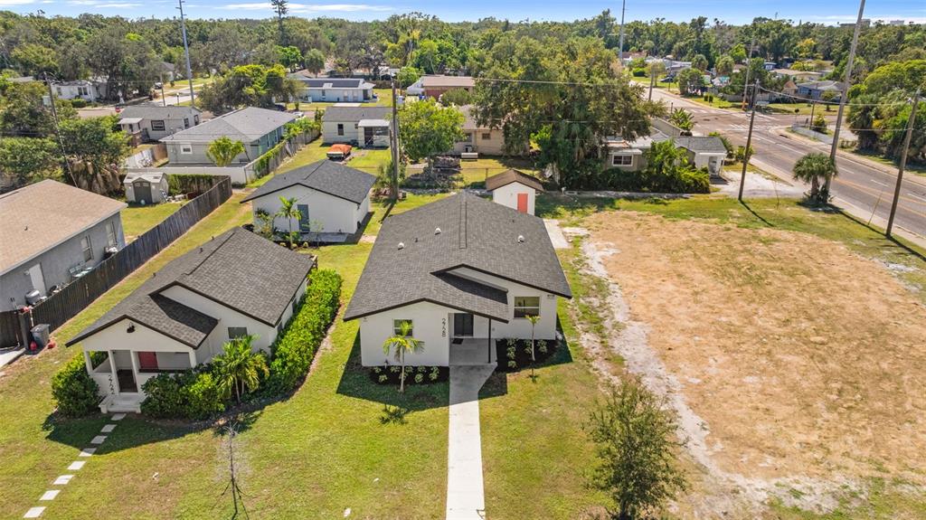 An aerial view shows a residential neighborhood with a vacant lot next to several houses — 2722 14TH AVENUE S, ST PETERSBURG, FL