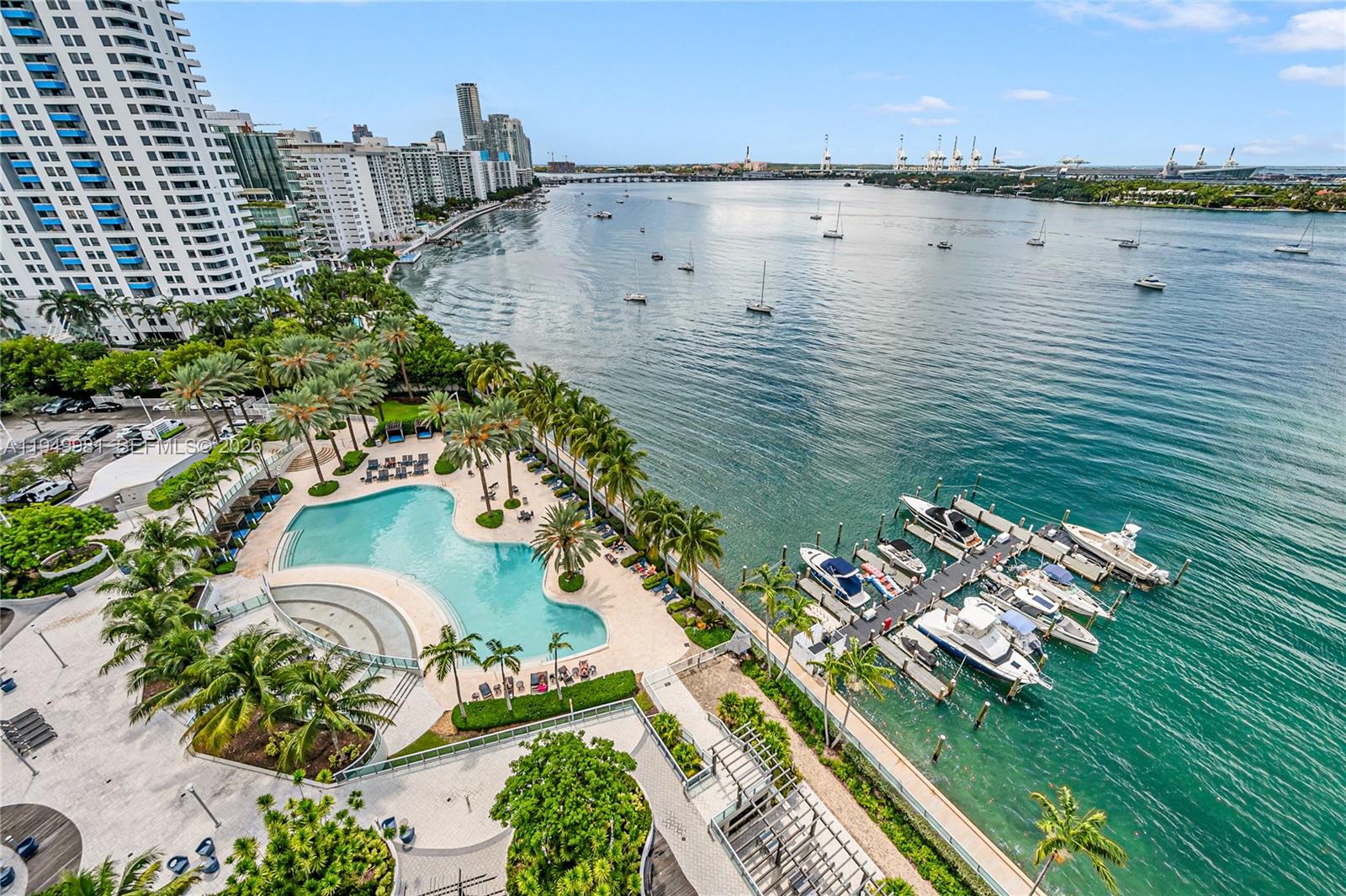 An aerial view shows a waterfront pool area, a private boat dock, and high-rise buildings — 1500 Bay Rd # 1536S, Miami Beach FL 33139, MIAMI BEACH, FL