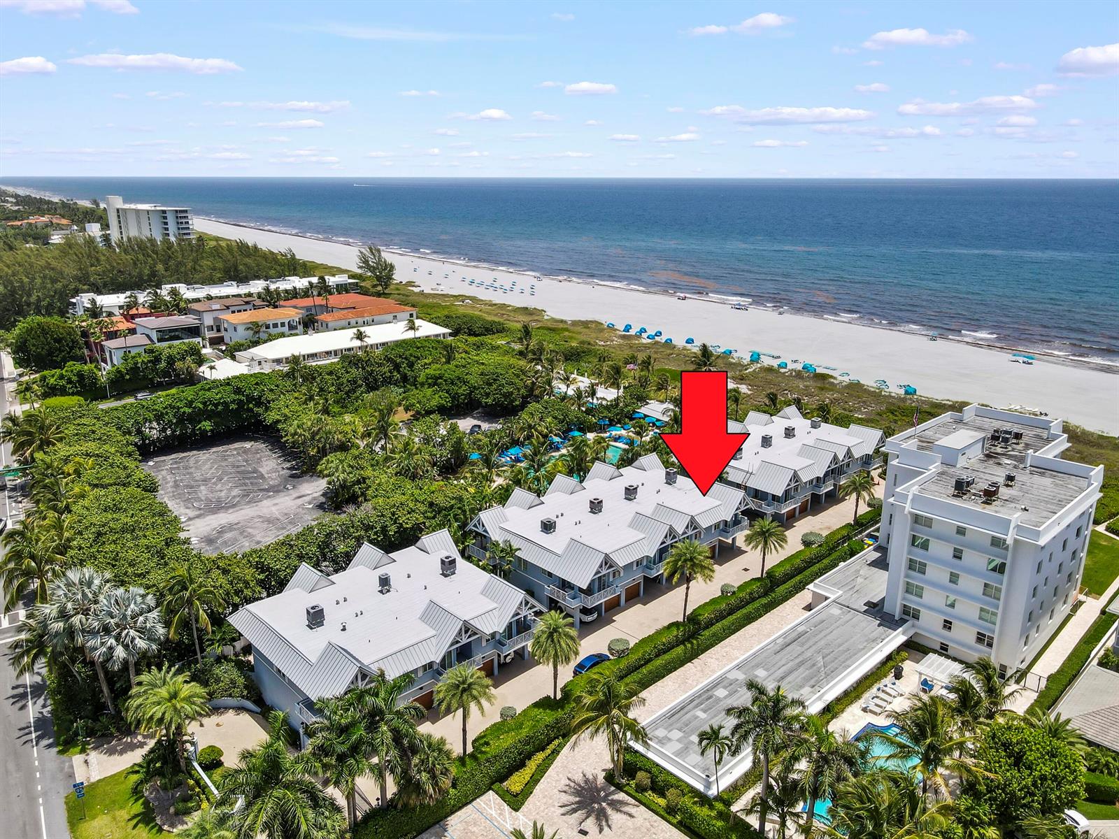 An aerial view shows a multi-story residential building complex near a sandy beach — 1835 S Ocean Boulevard # H, Delray Beach FL 33483, DELRAY BEACH, FL