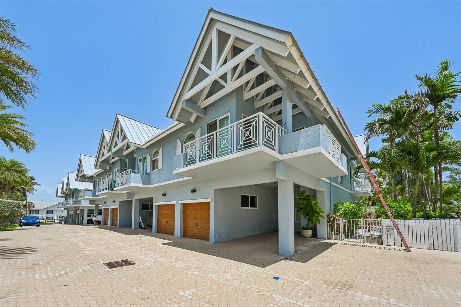 A row of light blue multi-story townhouses with elevated balconies and ground-level garages — 1835 S Ocean Boulevard # H, Delray Beach FL 33483, DELRAY BEACH, FL