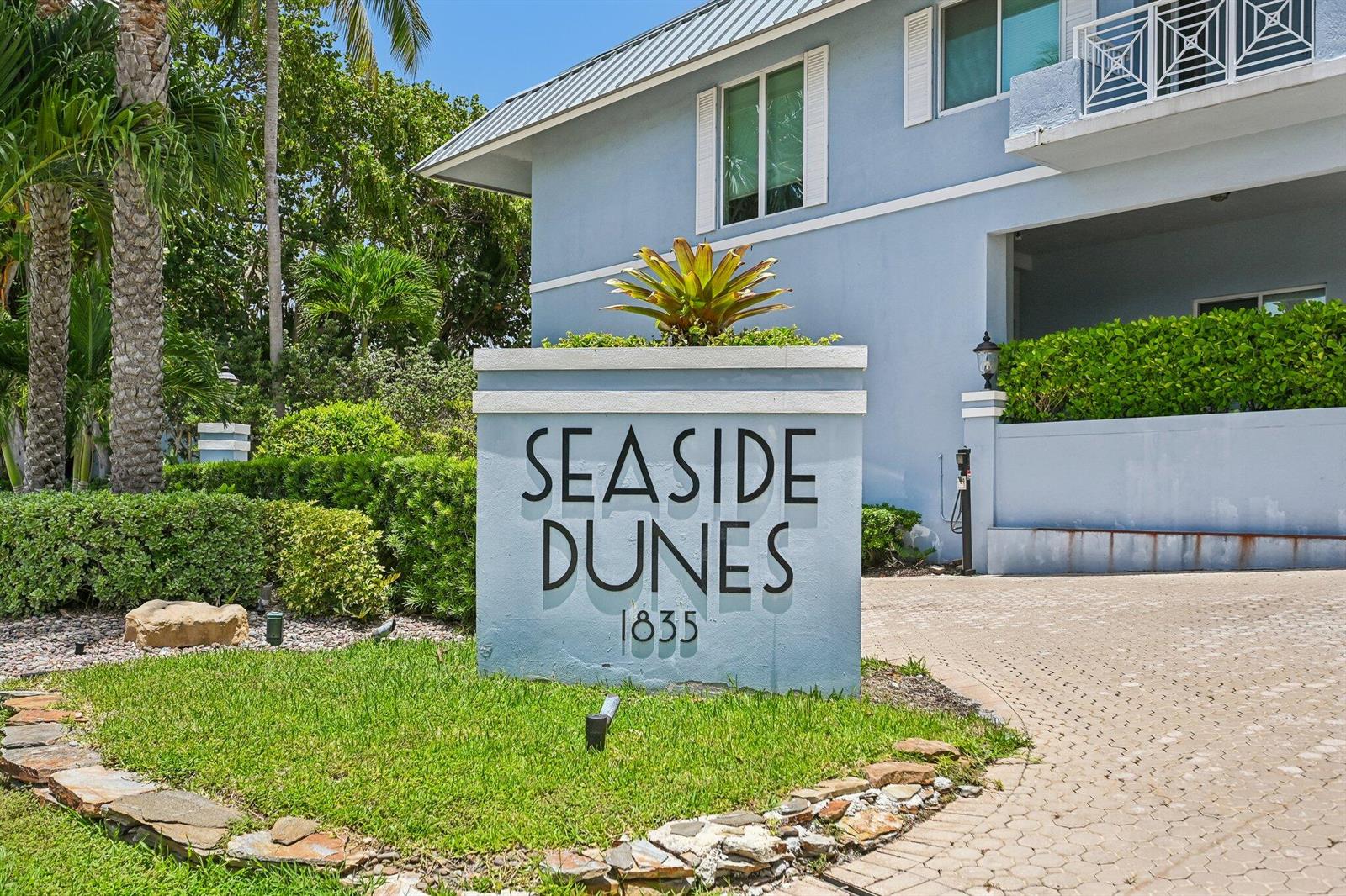 A light blue sign reading Seaside Dunes stands in front of a multi-story building — 1835 S Ocean Boulevard # H, Delray Beach FL 33483, DELRAY BEACH, FL