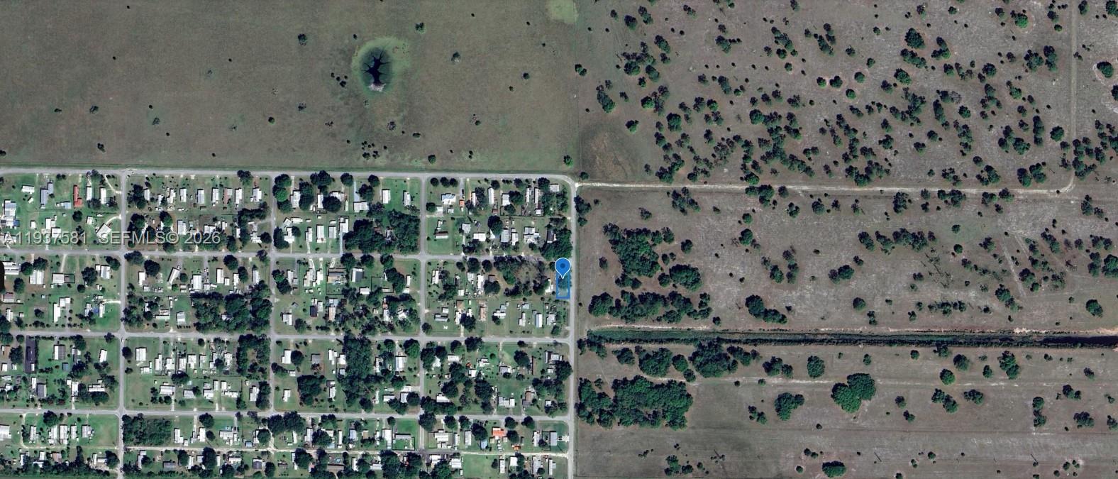 This aerial map shows a residential neighborhood bordering a large, undeveloped rural area — 323 Jordan Ter, Okeechobee FL 34974, OKEECHOBEE, FL