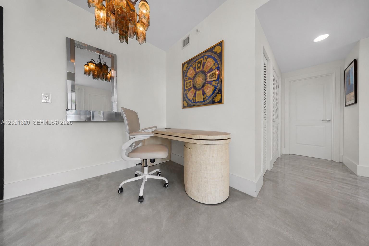 A home office features a desk, an office chair, a mirror, and a chandelier — 110 Washington Ave # 2505, Miami Beach FL 33139, MIAMI BEACH, FL
