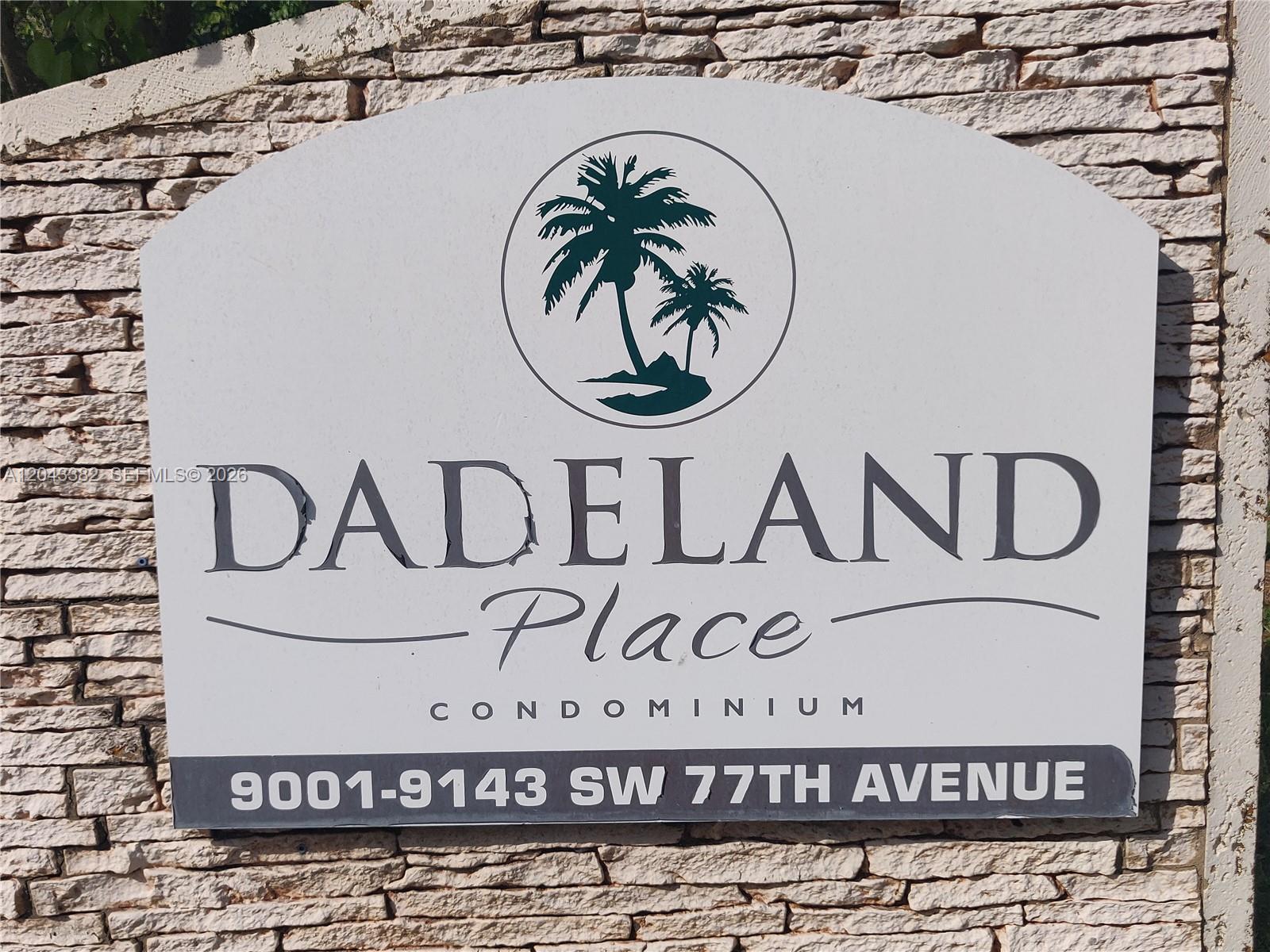 A sign for Dadeland Place Condominium is mounted on a textured stone wall — 9001 SW 77th Ave # C606, Miami FL 33156, MIAMI, FL
