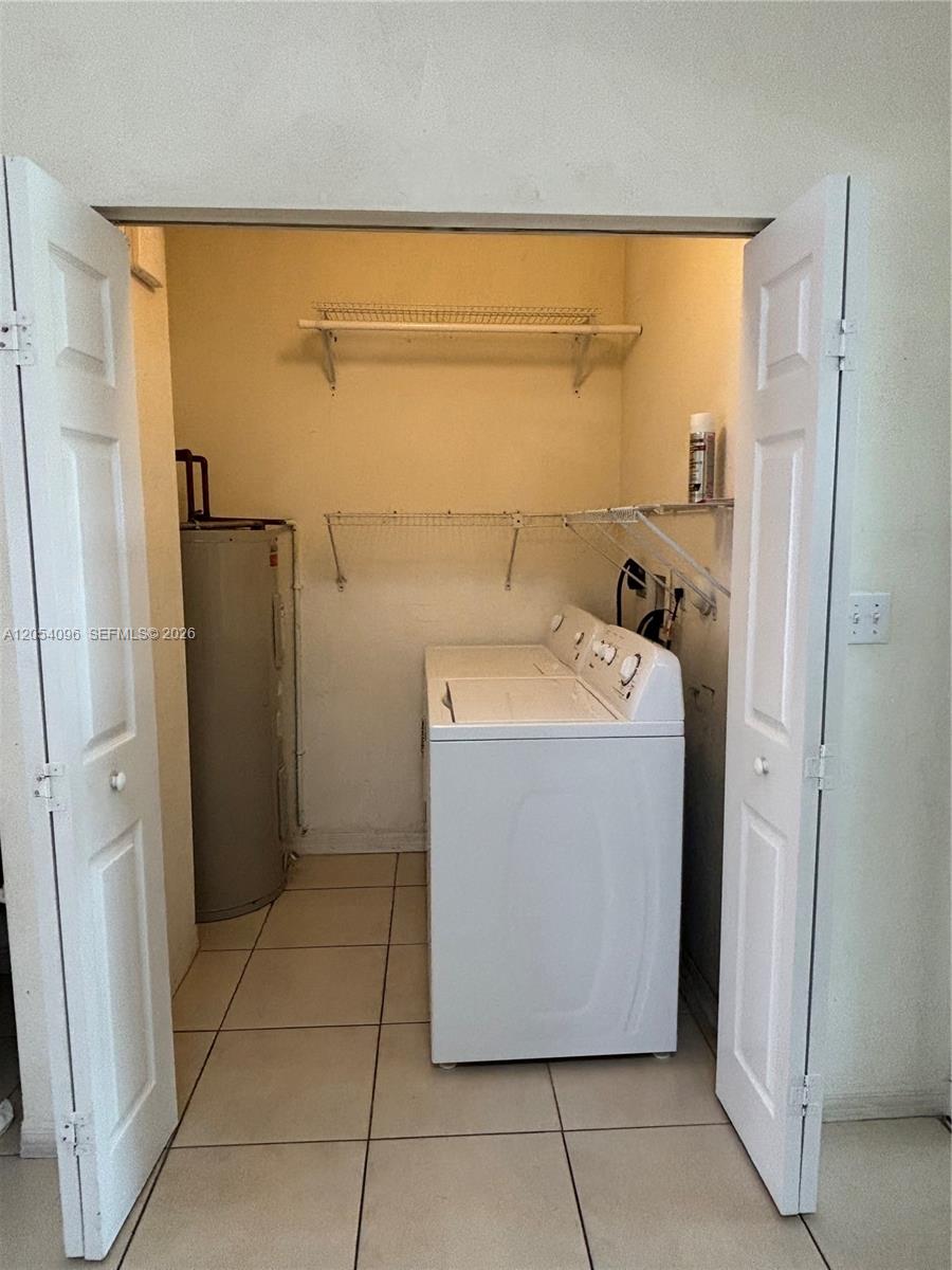 A laundry closet contains a white top-load washing machine and a water heater — 13781 SW 171st Ter, Miami FL 33177, MIAMI, FL
