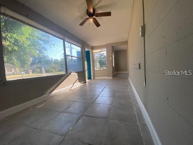 A sunroom with large windows, a ceiling fan, and light-colored tile flooring — 907 COLUMBIA STREET, ORLANDO, FL