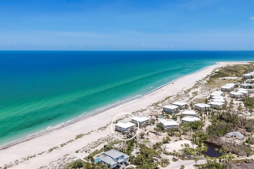 An aerial view shows a white beach house circled on a sandy coastline — 7554 PALM ISLAND DRIVE S UNIT 1813, PLACIDA, FL