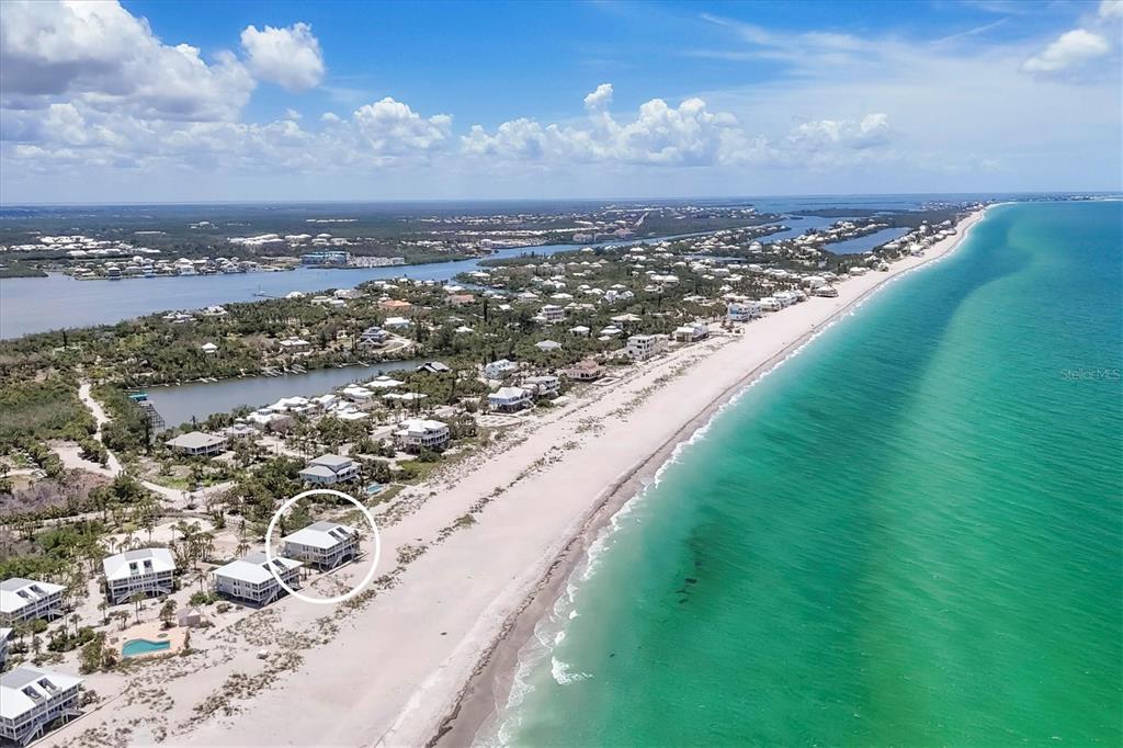 An aerial view shows a beachfront house circled on a sandy shore near the ocean — 7554 PALM ISLAND DRIVE S UNIT 1813, PLACIDA, FL