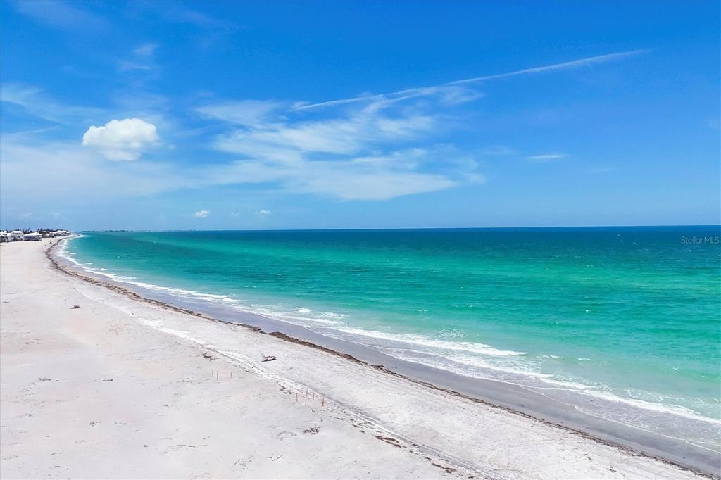An aerial view of a sandy beach meeting the turquoise ocean under a blue sky — 7554 PALM ISLAND DRIVE S UNIT 1813, PLACIDA, FL