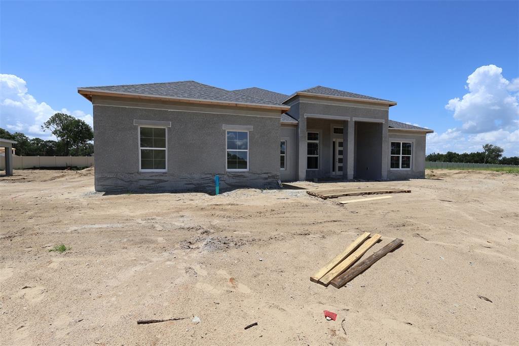 A kitchen with white cabinets, light countertops, a gas cooktop, and dark wood-look flooring — 3555 WOLVES CREEK PLACE, APOPKA, FL