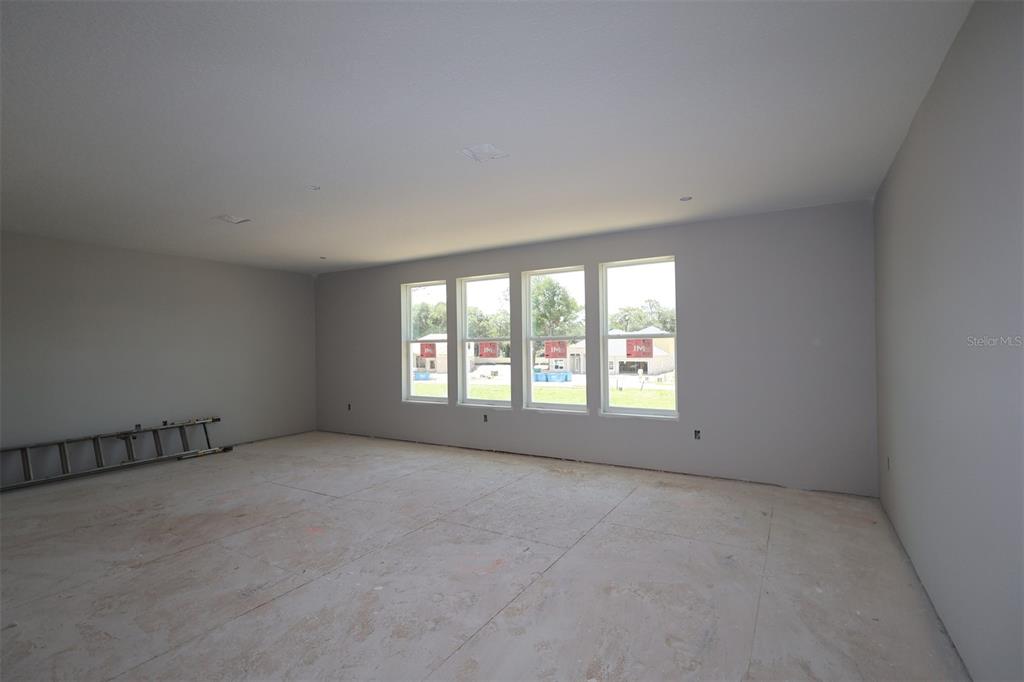 An empty room with gray walls, white trim, a single window, and unfinished flooring — 3555 WOLVES CREEK PLACE, APOPKA, FL