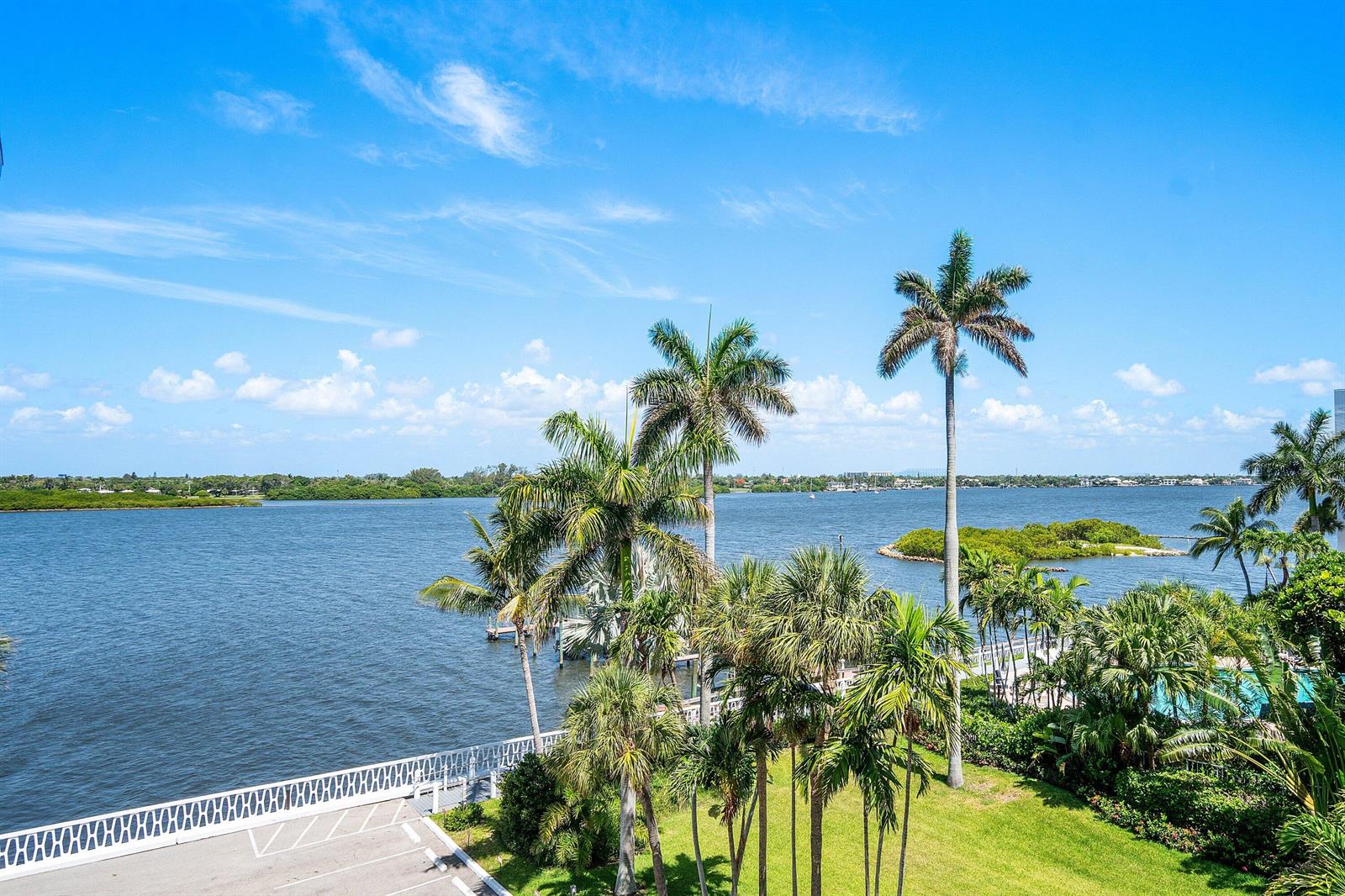 A view of a waterfront area with palm trees, a parking lot, and a dock — 2505 S Ocean Boulevard # 515, Palm Beach FL 33480, PALM BEACH, FL