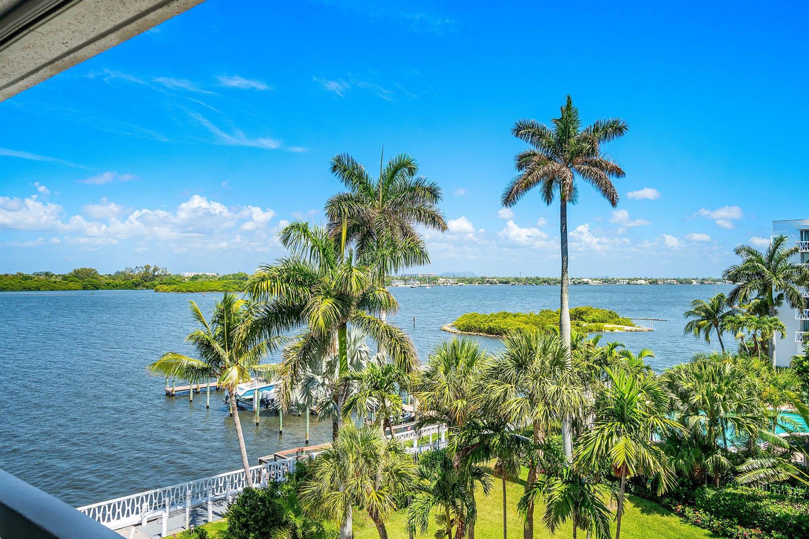 A view of a bay with palm trees, a dock, and a small island — 2505 S Ocean Boulevard # 515, Palm Beach FL 33480, PALM BEACH, FL