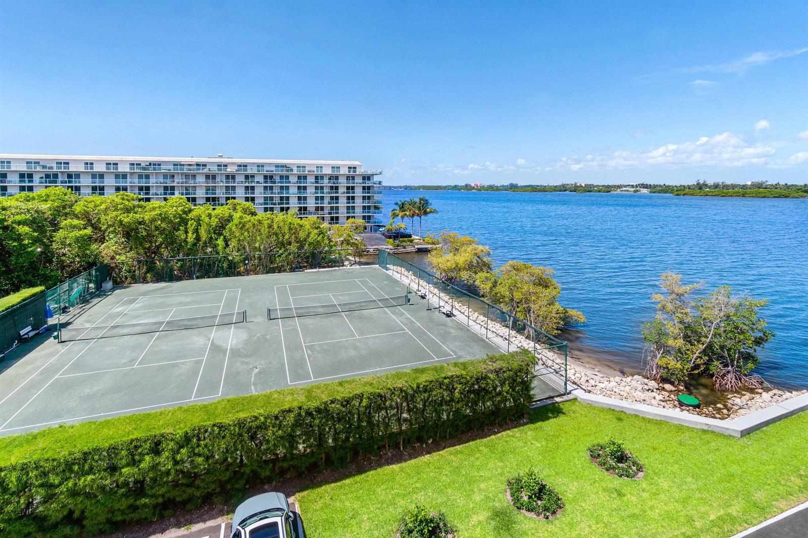 An elevated view of a tennis court next to a large body of water — 2505 S Ocean Boulevard # 515, Palm Beach FL 33480, PALM BEACH, FL