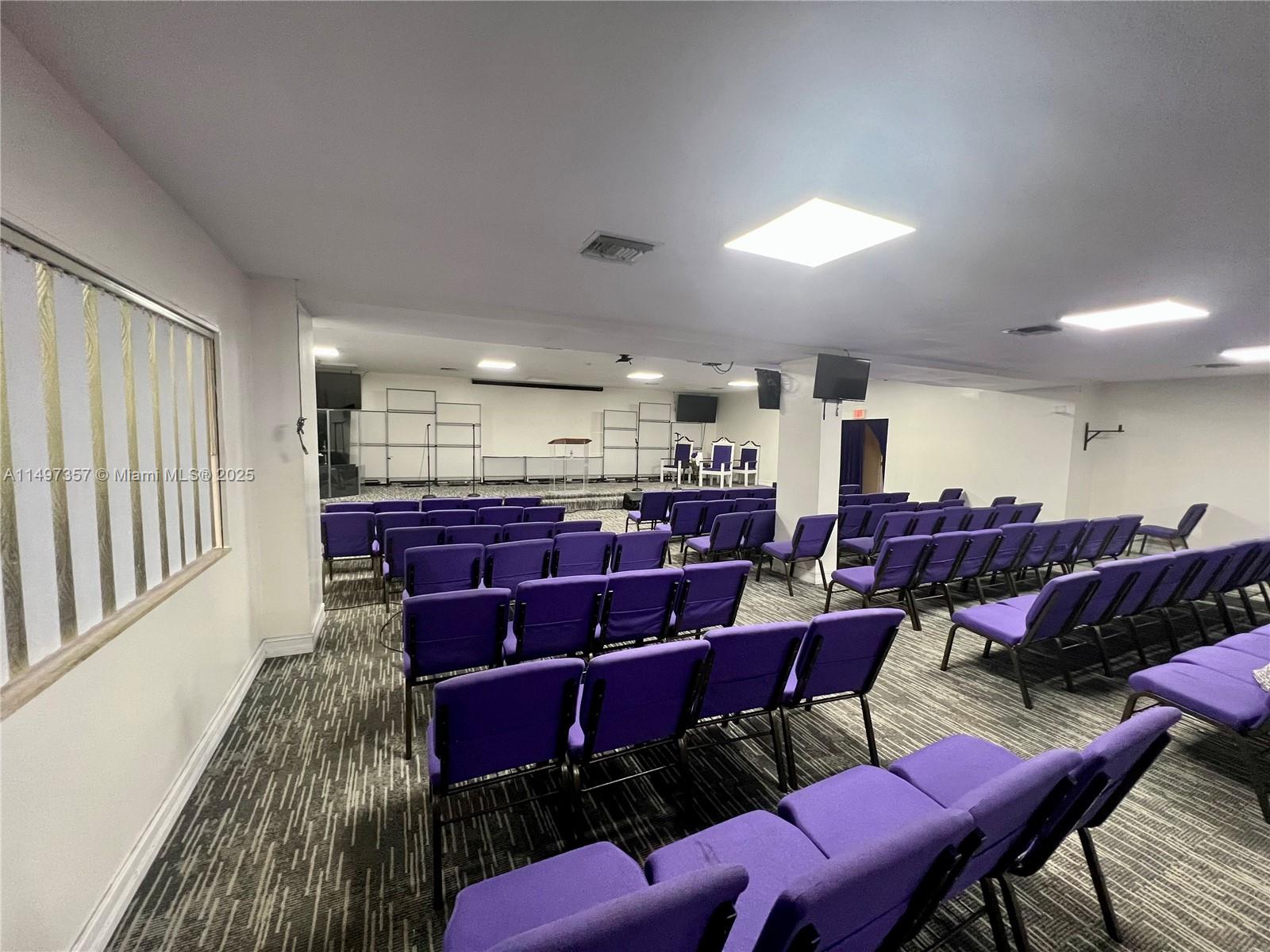 A church sanctuary features rows of purple chairs facing a stage with a podium — 6300 Pembroke Rd, Miramar FL 33023, MIRAMAR, FL