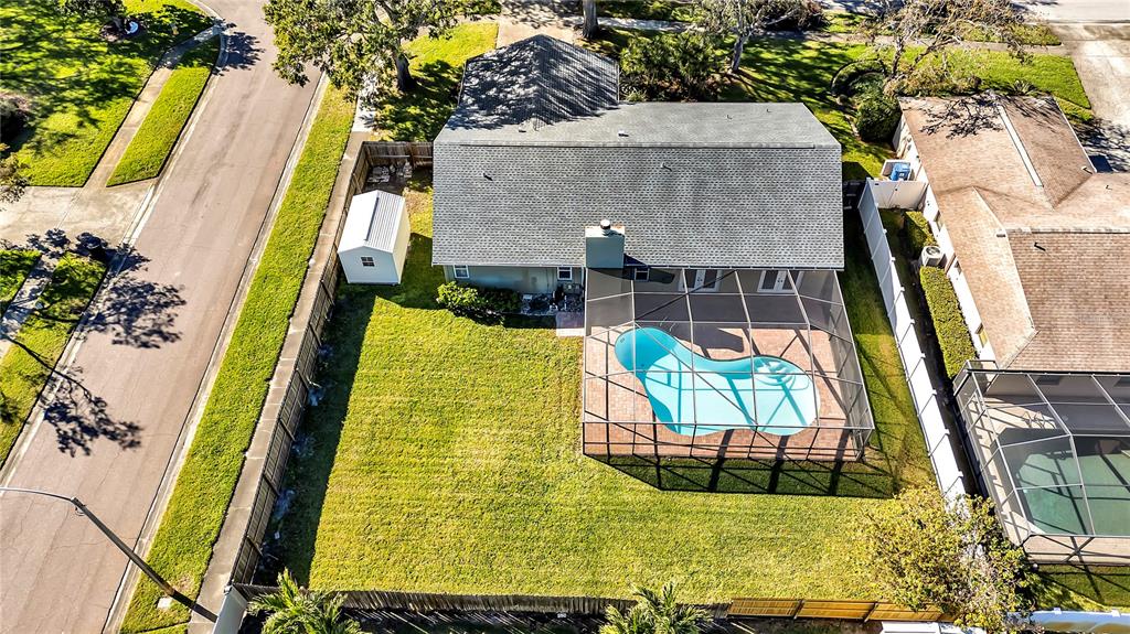 The exterior of a home features a brick walkway leading to a dark-framed front door — 7801 17TH WAY N, ST PETERSBURG, FL