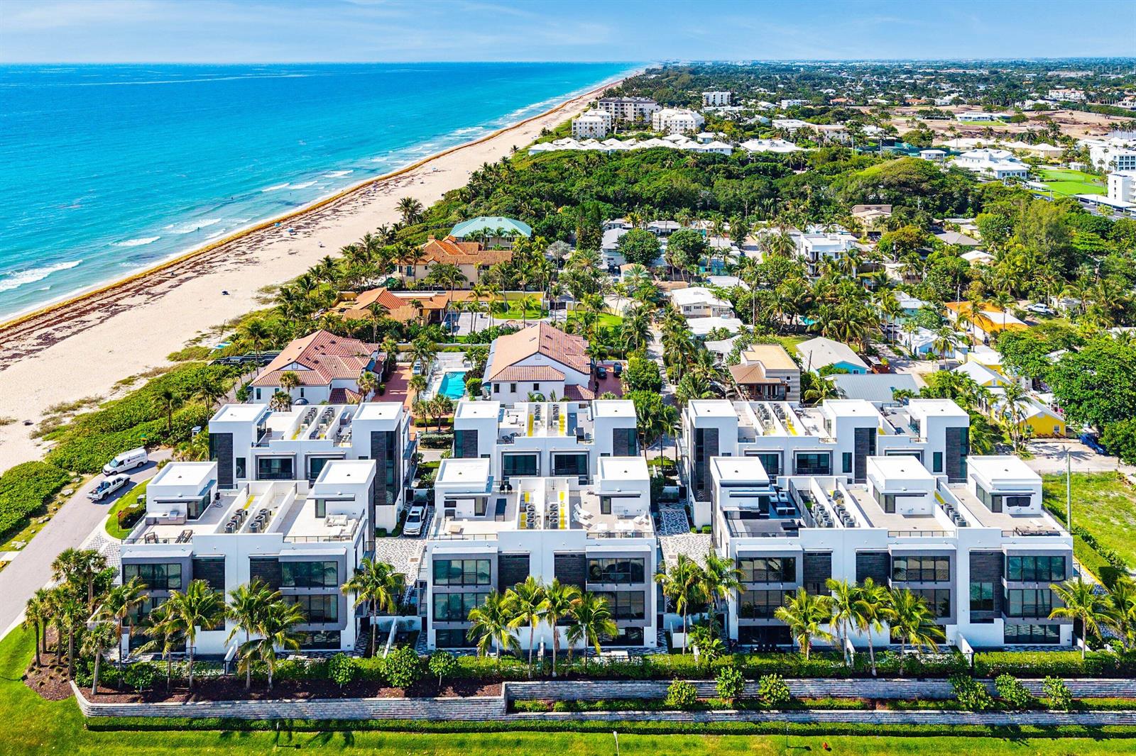 An aerial view of modern white townhouses located next to a sandy beach and ocean — 11501 Old Ocean Boulevard, Ocean Ridge FL 33435, OCEAN RIDGE, FL