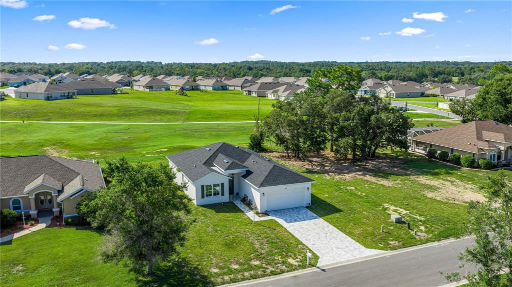 An aerial view shows a white single-story house with a dark roof and paved driveway — 4816 N CRESTLINE DRIVE, BEVERLY HILLS, FL