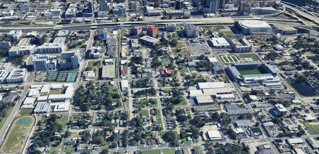 This aerial view shows a residential property marked with a star near a soccer stadium — 202 MCQUIGG AVENUE, ORLANDO, FL