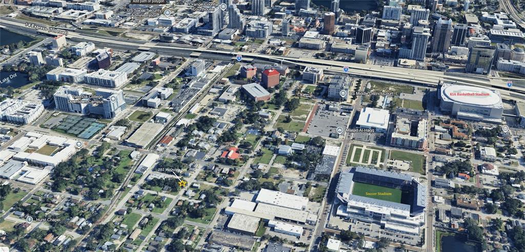 This aerial view shows a residential property marked with a star near a soccer stadium — 202 MCQUIGG AVENUE, ORLANDO, FL