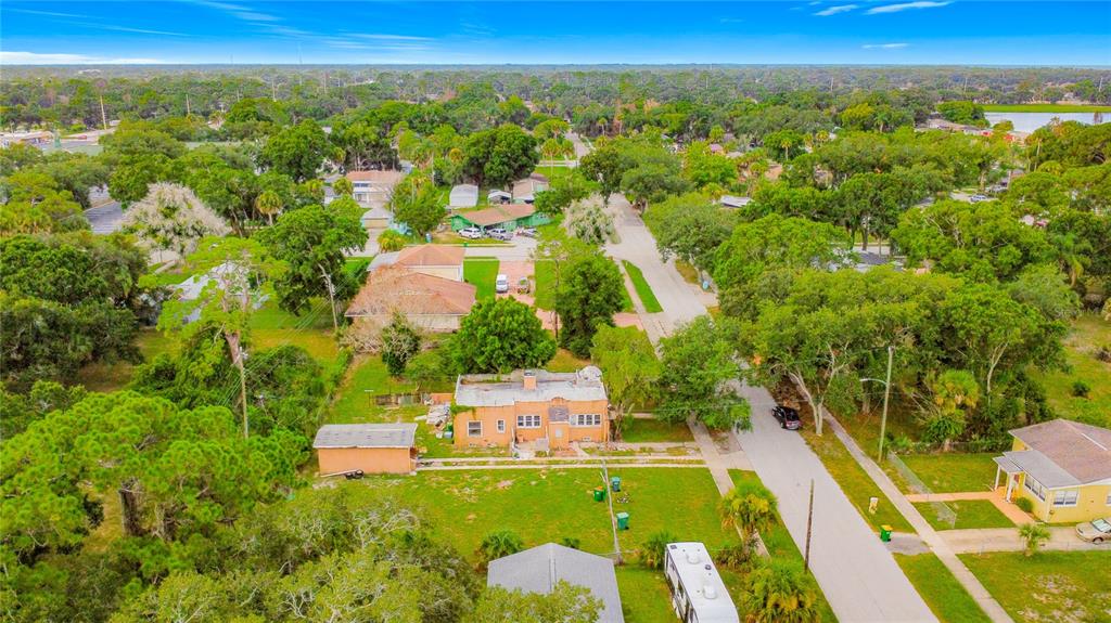 An aerial view shows a single-story house with a detached garage and a large yard — 618 S VARR AVENUE, COCOA, FL