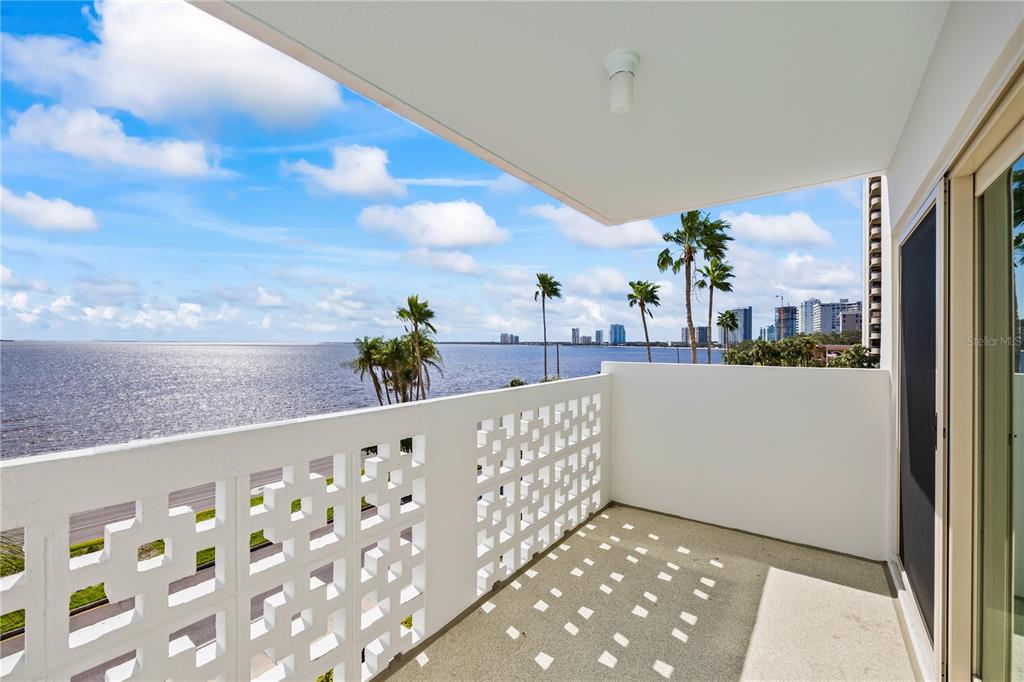 A balcony with a white decorative concrete railing overlooks a large body of water — 2401 BAYSHORE BOULEVARD UNIT 410, TAMPA, FL