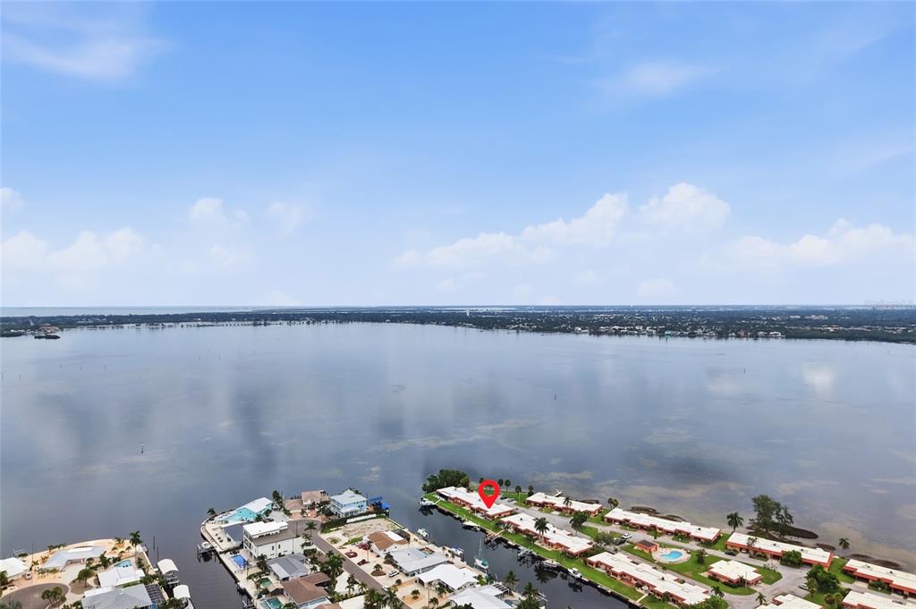 An aerial view shows a waterfront residential complex with a red pin marking a unit — 3844 CATALINA DRIVE UNIT 3844, BRADENTON, FL