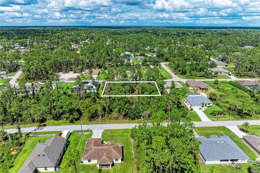 An aerial view shows a rectangular vacant lot surrounded by trees and residential houses — 1139164804, 1139164805 FOXGLOVE AVENUE Lot 4, lot 5, NORTH PORT, FL